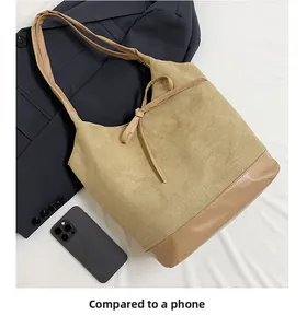 Detailed comparison of the large corduroy tote bag size against a modern smartphone