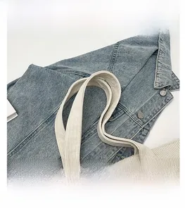 Detail shot showing thick corduroy texture and sturdy handle of the cream tote bag