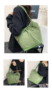 Detail view of large green tote bag with bow accent and textured fabric finish