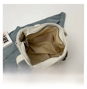 Internal view of a large cream corduroy tote bag with durable khaki lining and inner pocket