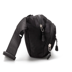 Side view of multi-pocket black nylon chest bag with adjustable woven straps and dual zippers