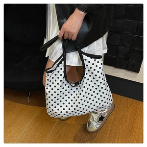 Detailed shot of large capacity polka dot tote bag with reinforced black canvas handles