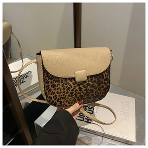 Detail of saddle bag featuring beige pebbled leather and leopard print pattern design