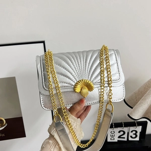 Silver quilted shell crossbody bag with golden seashell lock and chain strap