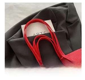 Close-up of red lychee pattern tote bag with double handles and clean stitching details