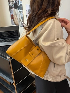 Minimalist yellow faux leather shoulder bag with vintage rivet grommet strap design