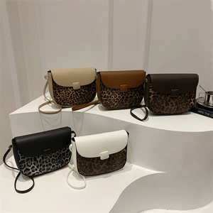 Winter 2025 minimalist saddle bags in five contrast leopard print colors on stairs