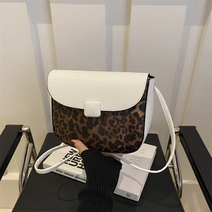 Chic winter saddle bag with white lychee grain leather and leopard print patchwork style