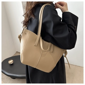 Chic beige pebble grain tote bag styled with a modern outfit for daily commuting look