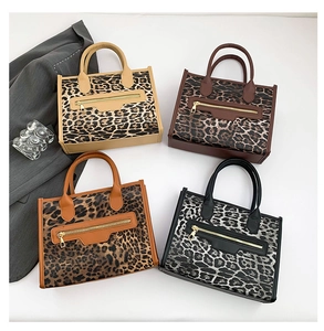 Detailed overhead view of four oversized leopard print tote bags in various stylish shades