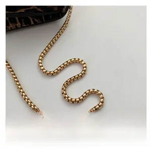 Detail of premium golden metal chain strap and leopard print faux leather bag finish