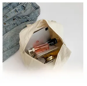 Interior view of spacious cream nylon tote bag showing storage for iPad and essentials