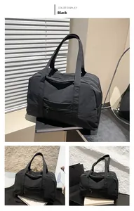 Detail view of black nylon travel bag showing lightweight material and front pocket