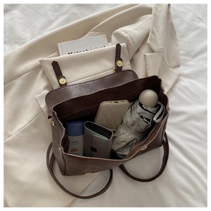 Detailed view of spacious interior of brown vintage leather backpack with daily essentials
