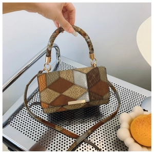 Detail of vintage patchwork handbag with animal texture and woven handle