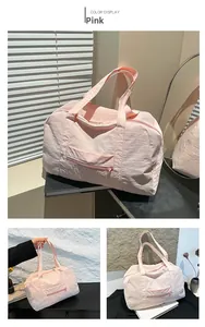 Pink nylon travel tote bag showing front zipper pocket and large capacity details