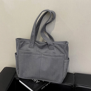Large gray corduroy tote bag with multiple pockets for daily commuting and casual use