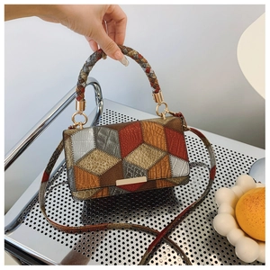 Close-up of retro patchwork handbag showing embossed animal texture and weave handle
