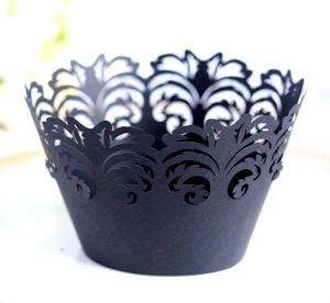Detailed laser-cut black paper cupcake wrappers with elegant vine and lace patterns