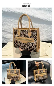 Detail view of khaki leopard print tote bag with gold zipper and dual handles