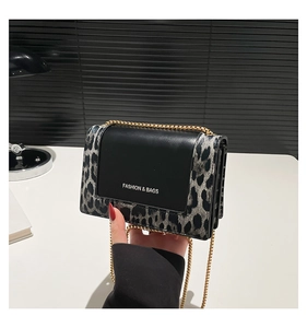 Close-up of leopard print small square bag featuring a gold chain and matte flap
