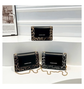 Detailed close-up of leopard print crossbody bags with elegant gold chain straps and textures