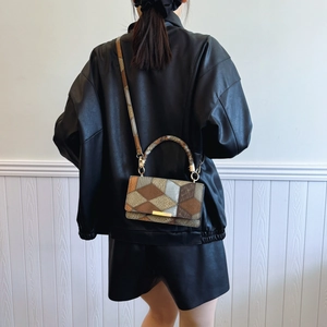 Vintage geometric patchwork crossbody bag with gold hardware and leather texture