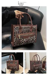 Close-up of leopard print tote bag with gold metal zipper and sturdy round handles