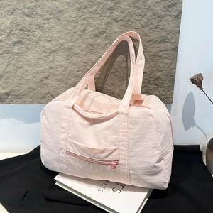 Light pink nylon travel bag with large capacity and minimalist design for commute
