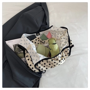 Interior view of polka dot canvas bag showing large capacity and internal pockets
