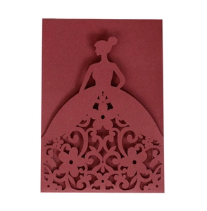 Close-up of laser-cut burgundy invitation card featuring a detailed floral dress silhouette
