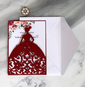 Macro shot of laser-cut princess silhouette invitation with white floral inner card