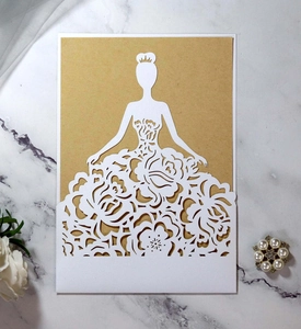 Detail of laser-cut wedding invitation featuring elegant floral silhouette on marble