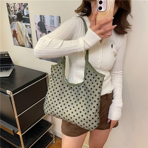 Minimalist light green canvas tote bag with black polka dots for daily casual use