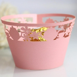 Pink laser-cut cupcake wrapper with teapot design and Ferrero chocolate inside