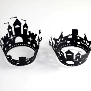 Laser-cut black castle cupcake liners with star and heart patterns for wedding party decor