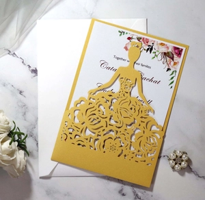 Detail of laser-cut gold wedding invitation featuring elegant rose dress silhouette design