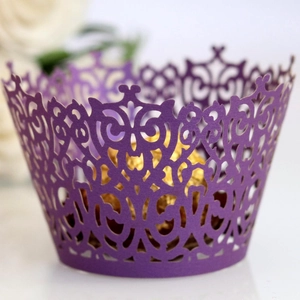 Laser-cut purple cupcake wrapper with intricate floral hollow design for wedding decor