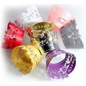 Pink laser cut cupcake wrappers with flowers, butterflies and it's a girl lettering for baby shower