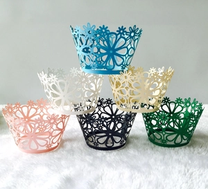 Detailed view of laser-cut cupcake wrappers in various colors for wedding party decoration