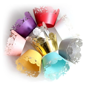 Assorted laser-cut cupcake wrappers with ocean shell patterns in various pearlized colors