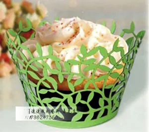 Close-up of bright green laser-cut cupcake wrapper with vine and leaf vine pattern