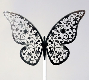 Elegant laser-cut silver butterfly cake topper with intricate floral hollow patterns