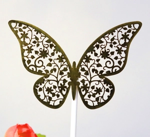 Elegant laser-cut silver butterfly cake topper with intricate floral pattern and stand