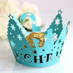 Laser cut light blue Christmas cupcake wrappers with tree and snowflake patterns