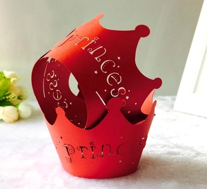 Laser cut red crown cupcake wrapper with princess text on warm white background