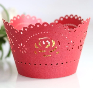 Elegant red laser cut cupcake wrapper with rose pattern on white background