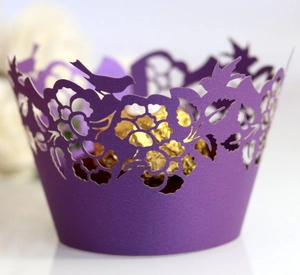 Deep purple laser cut cupcake wrapper with floral bird patterns and golden chocolate