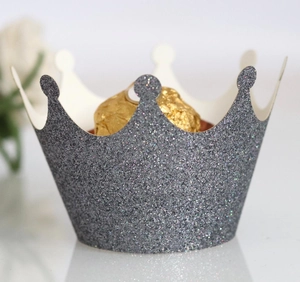 Close-up of laser-cut glitter grey crown cupcake wrapper with shimmering finish
