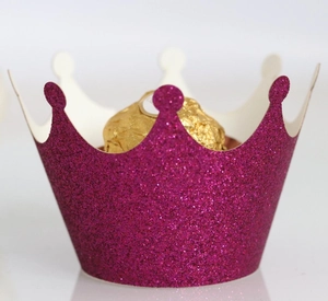 Macro shot of rose red glitter crown cupcake wrapper with luxury metallic finish
